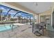 Relaxing pool area with covered patio and seating at 3636 Aruba Ct, Punta Gorda, FL 33950