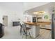 Kitchen boasts light wood cabinets, stainless steel appliances, and a breakfast bar at 3636 Aruba Ct, Punta Gorda, FL 33950