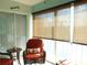 Relaxing sunroom with wicker furniture and window shades at 5725 Greenwood Ave # 4, North Port, FL 34287