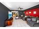 Living room with grey sectional sofa and large TV at 21451 Glendale Ave, Port Charlotte, FL 33952