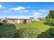 Large backyard with grassy lawn, patio, and grill at 21451 Glendale Ave, Port Charlotte, FL 33952