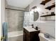 Clean bathroom with a bathtub, shower, and updated vanity at 21451 Glendale Ave, Port Charlotte, FL 33952