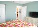 Bedroom with floral bedding, dresser, and access to other rooms at 5725 Greenwood Ave # 4, North Port, FL 34287