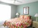 Bedroom with floral bedding, nightstands, and a window at 5725 Greenwood Ave # 4, North Port, FL 34287