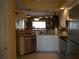 L-shaped kitchen with granite countertops and stainless steel appliances at 5725 Greenwood Ave # 4, North Port, FL 34287