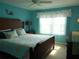 Main bedroom with a king-size bed and teal walls at 5725 Greenwood Ave # 4, North Port, FL 34287