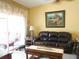 Living room with leather sofa and access to a patio at 5725 Greenwood Ave # 4, North Port, FL 34287
