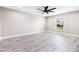 Bright bedroom with wood-look flooring and a ceiling fan at 16098 Overdale Ct, Punta Gorda, FL 33955