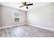 Bedroom with window, ceiling fan, and laminate wood flooring at 16098 Overdale Ct, Punta Gorda, FL 33955