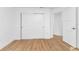 Well-lit bedroom with wood-look floors and access to another room at 17088 Doyle Ave, Port Charlotte, FL 33954