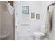 Clean bathroom with toilet, shower, and window with shutters at 1945 Jamaica Way, Punta Gorda, FL 33950