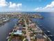 Aerial view of house on canal with boat and lush landscaping at 1945 Jamaica Way, Punta Gorda, FL 33950