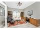 Spacious home office with built-in shelves, comfortable seating, and hardwood floors at 1945 Jamaica Way, Punta Gorda, FL 33950