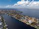 Aerial view of waterfront home with canal access and boat at 1945 Jamaica Way, Punta Gorda, FL 33950