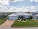House with metal roof, two-car garage and landscaped yard, aerial view at 1945 Jamaica Way, Punta Gorda, FL 33950