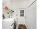 Functional laundry room, featuring washer, dryer, and ample shelving at 1945 Jamaica Way, Punta Gorda, FL 33950