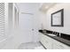 Bathroom features a single sink vanity, granite countertop, and linen closet at 1945 Jamaica Way, Punta Gorda, FL 33950