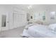 Bedroom featuring a queen bed, built-in shelves, and plantation shutters at 1945 Jamaica Way, Punta Gorda, FL 33950