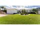 Beautiful waterfront home with a metal roof, two-car garage, and manicured lawn at 1945 Jamaica Way, Punta Gorda, FL 33950
