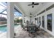 Relaxing screened-in pool area with patio furniture and water view at 1945 Jamaica Way, Punta Gorda, FL 33950