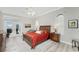 Spacious bedroom with king-size bed, wood furniture, and access to patio at 1945 Jamaica Way, Punta Gorda, FL 33950