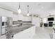 Modern kitchen with white cabinets, granite countertops, and stainless steel appliances at 1945 Jamaica Way, Punta Gorda, FL 33950