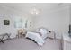 Bright bedroom with a queen-size bed, desk, and window with shutters at 1945 Jamaica Way, Punta Gorda, FL 33950