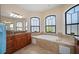 Bright bathroom with a soaking tub surrounded by windows and a granite countertop vanity with double sinks and modern fixtures at 2736 Magdalina Dr, Punta Gorda, FL 33950