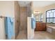 Well-lit bathroom featuring a tiled shower, vanity with granite countertop, and a large window next to a soaking tub at 2736 Magdalina Dr, Punta Gorda, FL 33950