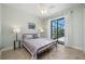 Bedroom with a view of the screened patio and lake at 2736 Magdalina Dr, Punta Gorda, FL 33950