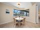 Breakfast nook featuring waterfront views from the bay window and a round white table with 4 upholstered chairs at 2736 Magdalina Dr, Punta Gorda, FL 33950