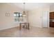 Dining space with a decorative chandelier, window with shutters, and tile floors at 2736 Magdalina Dr, Punta Gorda, FL 33950