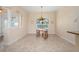 Bright dining area with decorative lighting fixture and arched window offering natural light at 2736 Magdalina Dr, Punta Gorda, FL 33950
