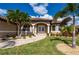 Attractive single-story home with tile roof, palm trees, and landscaped yard at 2736 Magdalina Dr, Punta Gorda, FL 33950