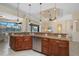 A kitchen island features granite counters, wood cabinets, and stainless appliances, with water views beyond at 2736 Magdalina Dr, Punta Gorda, FL 33950