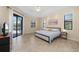 Main bedroom featuring a neutral color palette, tile floors, and sliding glass doors to the backyard at 2736 Magdalina Dr, Punta Gorda, FL 33950