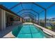 Lovely screened-in pool with patio and view of the house at 2736 Magdalina Dr, Punta Gorda, FL 33950