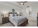 Main bedroom with wood bed frame and ensuite bathroom at 43050 Greenway Blvd # 614, Punta Gorda, FL 33982