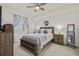 Cozy bedroom with wood bed frame and ceiling fan at 43050 Greenway Blvd # 614, Punta Gorda, FL 33982