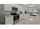 Modern kitchen with stainless steel appliances and granite countertops at 43050 Greenway Blvd # 614, Punta Gorda, FL 33982