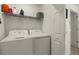 Laundry room with washer, dryer, and shelving at 43050 Greenway Blvd # 614, Punta Gorda, FL 33982