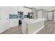 Modern kitchen with white cabinets, stainless steel appliances, and a large island at 5932 Brickell Dr, North Port, FL 34288