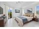 Main bedroom with a king-size bed and access to the backyard at 7116 Quigley St, Englewood, FL 34224