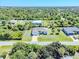 House with a large backyard and a paved driveway at 7116 Quigley St, Englewood, FL 34224