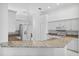 Kitchen boasts granite countertops and white cabinetry at 7116 Quigley St, Englewood, FL 34224