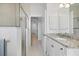 Clean bathroom with granite countertop and walk-in shower at 7116 Quigley St, Englewood, FL 34224