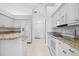 Kitchen with granite countertops and white cabinetry at 7116 Quigley St, Englewood, FL 34224
