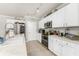 Modern kitchen with white cabinets, stainless steel appliances and breakfast bar at 7773 Mikasa Dr, Punta Gorda, FL 33950