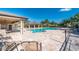 Community pool with lounge chairs and shaded seating at 7773 Mikasa Dr, Punta Gorda, FL 33950