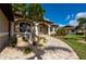 Home exterior showcasing a paved walkway and lush landscaping at 2736 Magdalina Dr, Punta Gorda, FL 33950